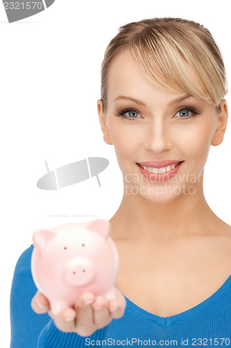 Image of lovely woman with piggy bank