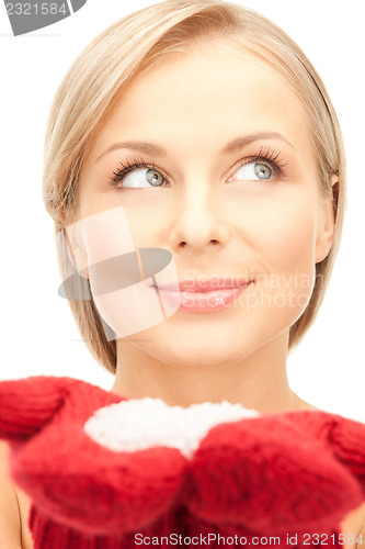 Image of beautiful woman in red mittens with snow