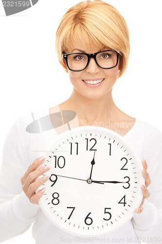 Image of woman holding big clock