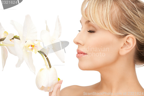 Image of beautiful woman with orchid flower 