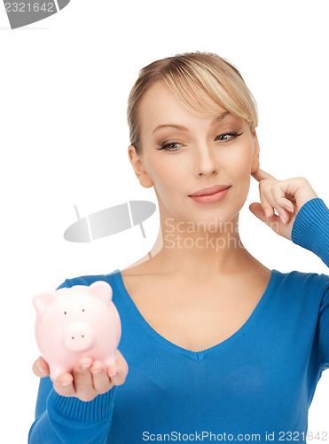 Image of lovely woman with piggy bank