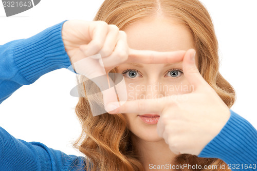 Image of lovely woman creating a frame with fingers