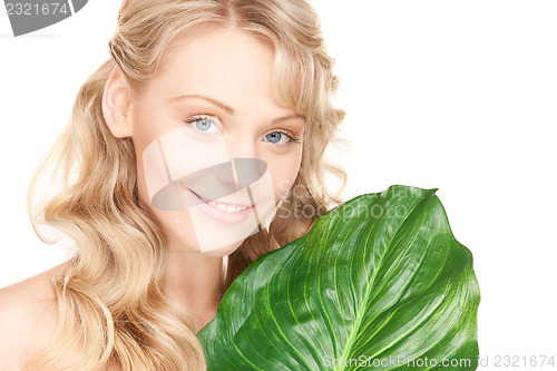Image of woman with green leaf