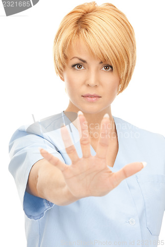 Image of attractive female doctor showing stop gesture