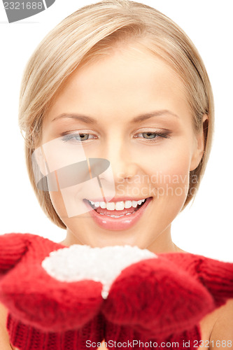 Image of beautiful woman in red mittens with snow