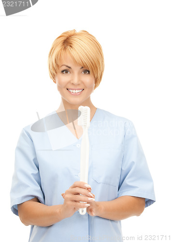 Image of doctor with toothbrush