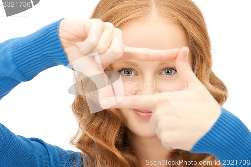 Image of lovely woman creating a frame with fingers