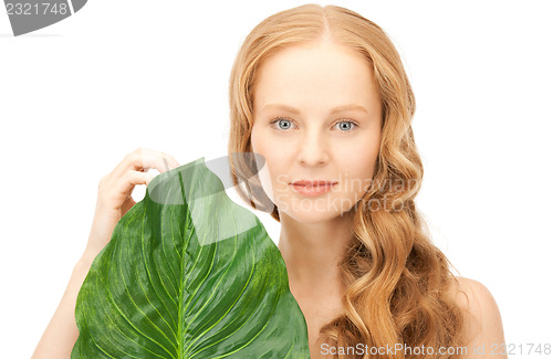 Image of woman with green leaf
