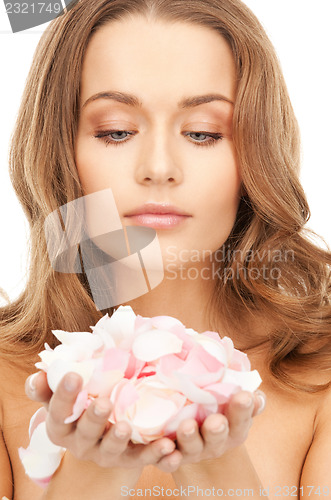 Image of beautiful woman with rose petals