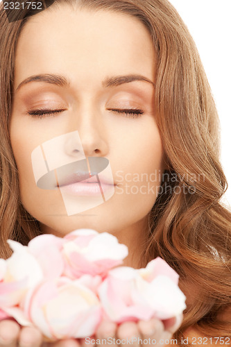 Image of beautiful woman with rose petals