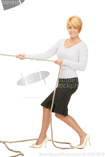 Image of business woman pulling rope