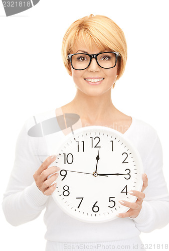 Image of woman holding big clock