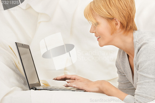 Image of happy woman with laptop computer