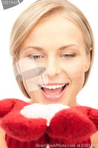 Image of beautiful woman in red mittens with snow