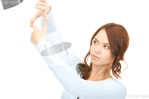 Image of lovely woman creating a frame with fingers