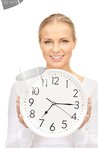 Image of woman holding big clock