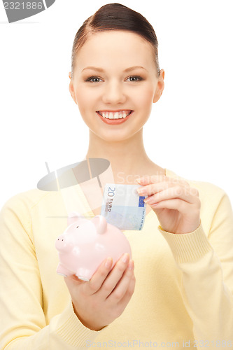 Image of lovely woman with piggy bank 