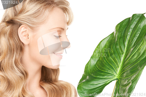Image of woman with green leaf