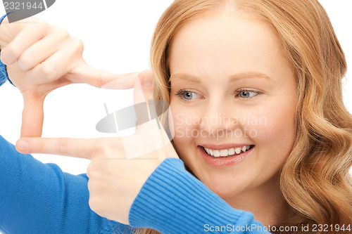 Image of lovely woman creating a frame with fingers