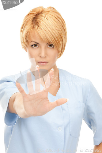 Image of attractive female doctor showing stop gesture