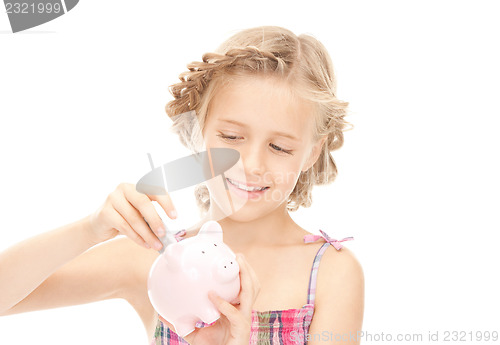 Image of little girl with piggy bank and money