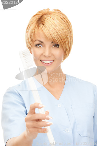 Image of doctor with toothbrush