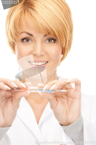 Image of attractive female doctor with thermometer