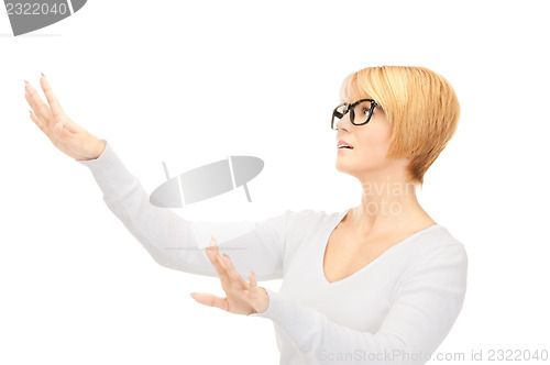 Image of businesswoman working with something imaginary 