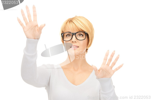 Image of businesswoman working with something imaginary 