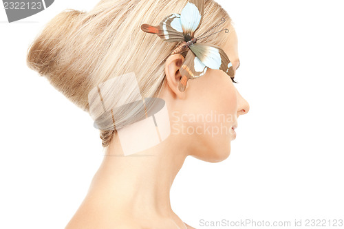 Image of beautiful woman with butterfly in hair