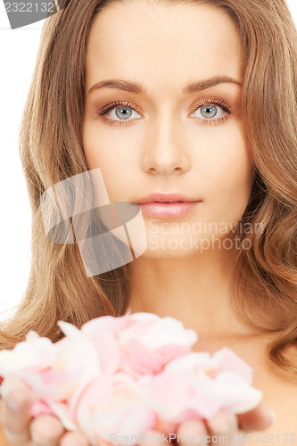 Image of beautiful woman with rose petals