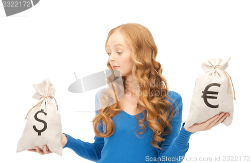 Image of woman with euro and dollar bags