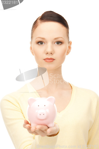 Image of  lovely woman with piggy bank	 
