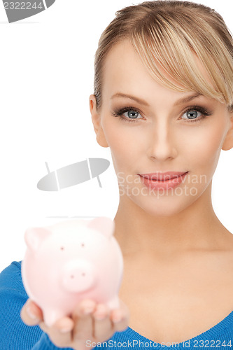 Image of lovely woman with piggy bank