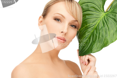 Image of woman with green leaf