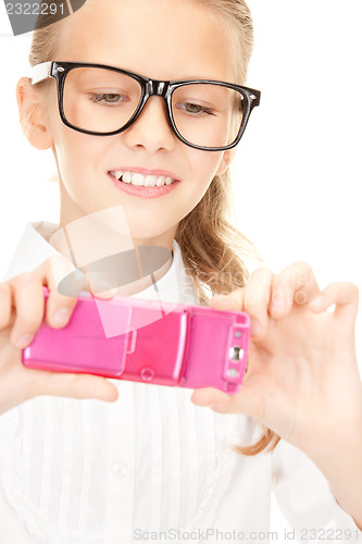 Image of happy girl taking picture with cell phone