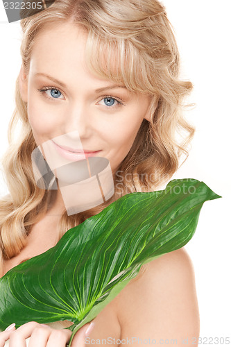 Image of woman with green leaf