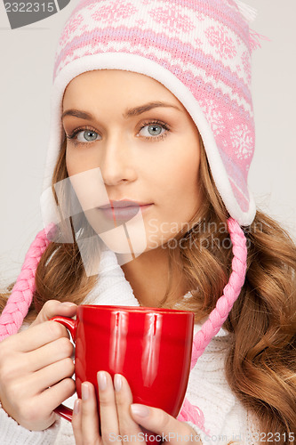 Image of beautiful woman with red mug