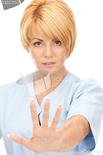 Image of attractive female doctor showing stop gesture