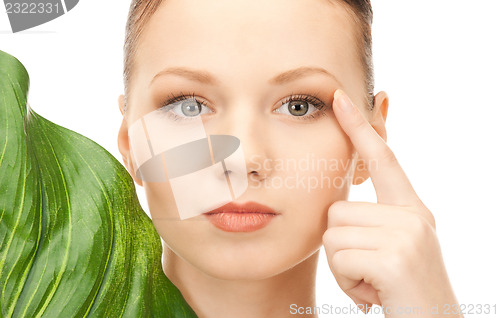 Image of woman with green leaf
