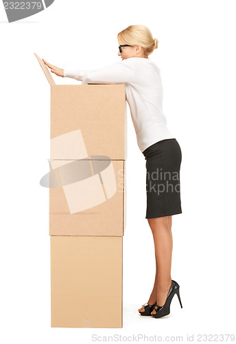 Image of  attractive businesswoman with big boxes	 