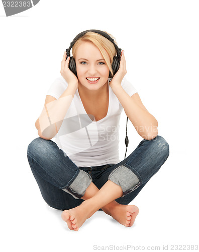 Image of  happy teenage girl in big headphones