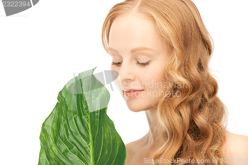 Image of woman with green leaf