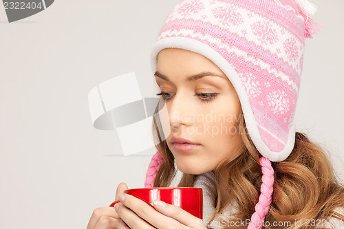 Image of beautiful woman with red mug