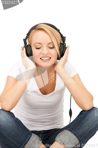 Image of  happy teenage girl in big headphones