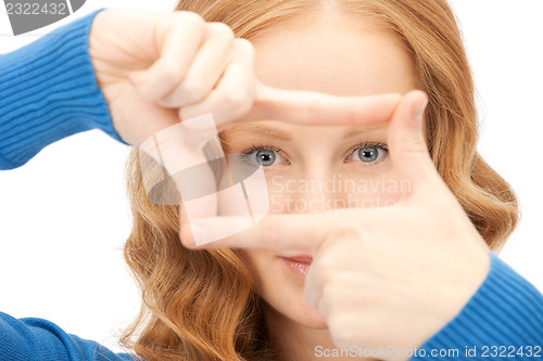 Image of lovely woman creating a frame with fingers