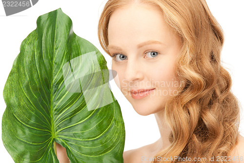 Image of woman with green leaf