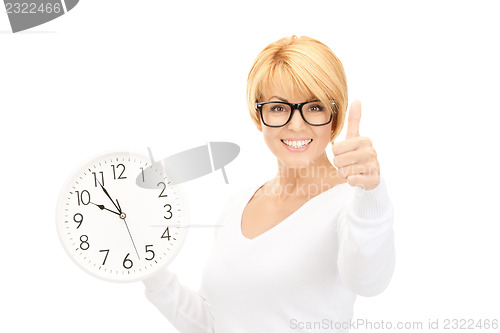 Image of woman holding big clock