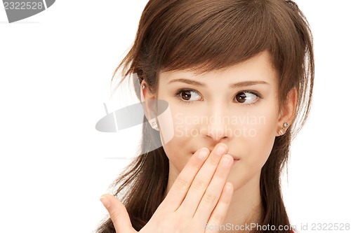 Image of teenage girl with palms over mouth