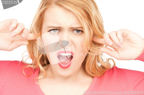 Image of woman with fingers in ears